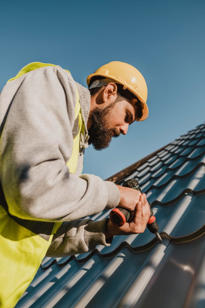 man-working-roof-with-drill-low-view (1)